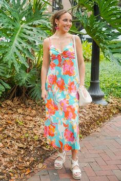 Embrace sunny vibes with the Sun Valley Dress. This maxi dress features adjustable spaghetti straps and a playful keyhole cutout with an adjustable tie string, perfect for a summer day. The flowy style and aqua blue base with pink, red, yellow, and white florals will make you stand out and feel fabulous. It is lightweight, has a knee length liner, and fits true to size.

85% Rayon, 15% Nylon

Brand: En Creme

Model is 5'8" and is wearing a small Sunny Vibes, White Florals, Sun Valley, Summer Day, New Arrival Dress, Aqua Blue, Pink Red, Savannah Chat, Red Yellow