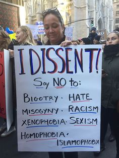 a woman holding a sign that says i dissent say no to