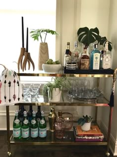 a bar cart filled with bottles and glasses