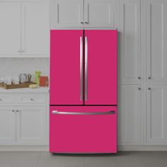 a bright pink refrigerator in a white kitchen