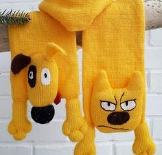 two yellow knitted animals hanging from a tree