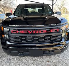 the front end of a black chevrolet truck