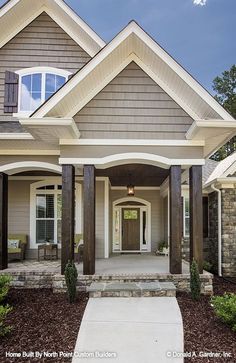 the front entrance to a house with columns and pillars