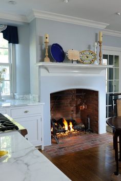 a fireplace in a living room next to a table