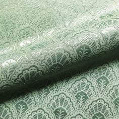 green and white lace fabric with an intricate design on the top, in two rows