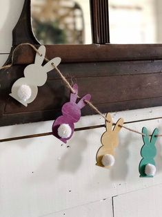 some paper bunnies are hanging from a rope on a door frame with bunny and rabbit decorations