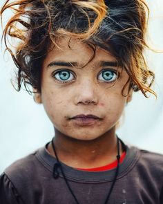 a close up of a child with blue eyes