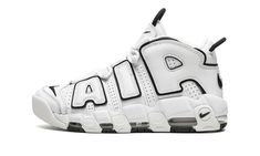 The Women’s Nike Air More Uptempo “White/Black” is a women’s-exclusive version of the ‘90s basketball shoe in a versatile white and black colorway.  The upper features large “AIR” branding outlined in black that brings a ‘90s-style, graffiti-inspired look to the table.  A black jeweled Swoosh is found on the heel and a black Swoosh is embroidered on the toe.  A black Swoosh appears on the tongue.  The shoe’s upper is constructed in perforated white leather.  Two pull tabs on the tongue and heel 90s Basketball Shoes, White Black Shoes, Nike Tenis, Nike Air More Uptempo, Nike Air More, Black Jewel, Hot Sneakers, Nike Womens, Nike Basketball