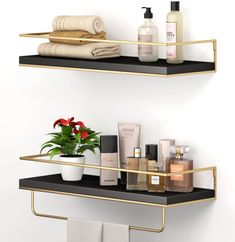 two white shelves with gold trim holding personal care items and flowers in vases on them