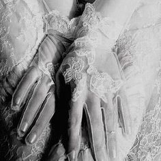 black and white photograph of woman's hands wearing lace gloves