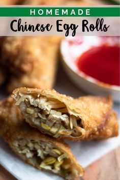 an egg roll is cut in half and sitting on a plate with sauces behind it