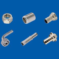 various types of metal fittings on a blue background