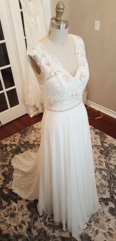 a wedding dress on display in front of a door