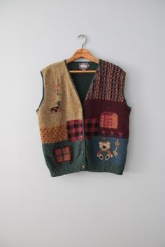 vintage rare essential cabin/cottage core aesthetic dark autumn color warmest wool intarsia knitwork vest. featuring cutest bear, duck and farm house in moody autumn front and pine green back. embossed flower buttons in antiqued brass.  100% wool   Made by Woolrich  Fits best like oversize or large (tag vintage size L): 16" shoulders 44" bust 22" length Condition: excellent! ✮ shop our selection of vintage knitwear here: https://etsy.me/3XGKMBb ✮ shop The Veiled Ghost handmade jewelry: https://etsy.me/32CDNCC ✮ shop Adrian Company Vintage: https://etsy.me/3u2Ewbi Knitwear Aesthetic, Moody Autumn, Etiquette Vintage, Cabin Cottage, Vintage Knitwear, Dark Autumn, Cottage Core Aesthetic, Wool Vest, Pine Green