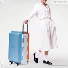 a woman in white is holding a blue and orange suitcase