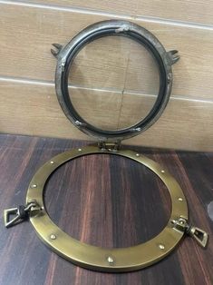 a metal ring with two handles on a wooden table