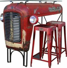 an old red truck with two stools and a table in front of it on a white background