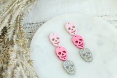 "These are such fun and festive acrylic earring pieces made with 3 Halloween skull charms. You get a light pink Skull, a metallic hot pink skull and a holographic silver Skull Charm. You get enough pieces to make three pairs of acrylic earrings (NO HARDWARE IS INCLUDED) These measure just about 2\" long.  NO Hardware is included! You will receive enough pieces to make 3 total pairs, 6 witch hats, 6 pumpkins, and 6 white ghosts" Pink Dangle Jewelry For Halloween, Pink Halloween Party Earrings, Pink Skull Jewelry For Halloween, Skull Earring, Earring Stack, Pink Holographic, Laser Projects, Acrylic Blanks, Witch Hats