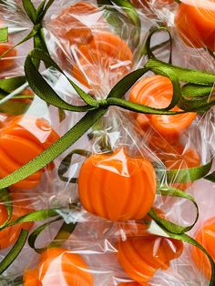 orange candies wrapped in cellophane with green ribbon