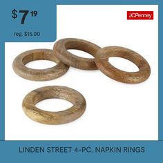 four wooden rings are shown with the price tag for each item in front of them