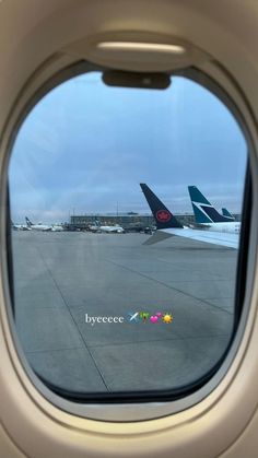 an airplane window looking out at the tarmac