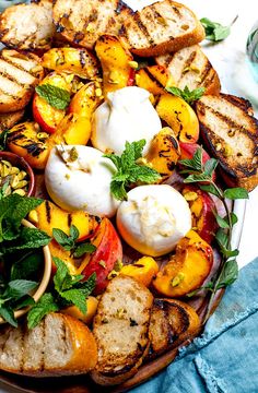 grilled vegetables on a platter with herbs and mozzarella cheese for toppings