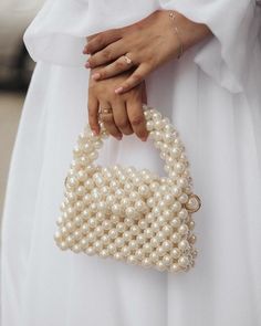 Zuruj Pearl & Crystal Handmade Bags Elegance in Every Detail Introducing the new line of luxurious handmade bags by Zuruj, meticulously crafted to bring timeless elegance to your collection. These exquisite bags are a perfect blend of pearls and crystals, reflecting the brand's commitment to quality and artistry. Features: - Handcrafted Masterpiece: Each bag is painstakingly handcrafted, ensuring that no two pieces are alike. - Luxurious Materials: Adorned with lustrous pearls and sparkling crys Pearl Purse, Pearl Clutch Bag, Pearl Handbag, Hand Beaded Bag, Bead Bag, Pearl Clutch, Purse White, Crystal Bags, Pearl Bag