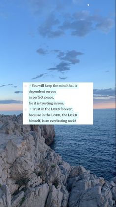 a person standing on top of a rocky cliff next to the ocean with a quote above it