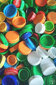 many different colored plastic cups are stacked together