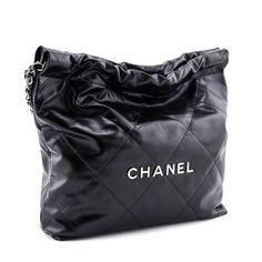 Irreverent cool with luxury finishing touches, this pristine Chanel 22 Bag is the current model you've been searching for! The high shine black calfskin exterior is finished with oversized flat diamond quilting, and matte silver-tone hardware. Front and center, individual hardware letters spell out CHANEL, set below the double interwoven leather & chainlink straps with a hanging branded medallion for added impact. The lightly cinched top, flat base, and soft structure create an edged up paper ba Chanel 22 Bag, Cinched Top, Chanel 22, Bag Silhouette, Chanel Set, Dream Bag, Green Handbag, Girls Handbags, Chanel Purse