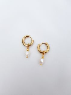 Mini hoop earrings with small pearl charm! These dainty freshwater baroque pearl earrings are perfect addition to you jewelry collection. Mixing all time favorite - hoops and all time classic -pearls, makes these earrings both- beautiful and timeless! It's definitely a must have! You also can take off pearl charms and have plain hoops earrings when needed! Check other pearl earrings here - https://www.etsy.com/shop/GinandJewelryShop?section_id=32608833 Message me if you need larger quantity than Everyday Pearl Drop Dangle Hoop Earrings, Everyday Hoop Earrings With Pearl Charm, Delicate Dangle Hoop Earrings With Pearl Charm, Gift 14k Gold Hoop Earrings With Pearl Chain, Everyday Pearl Charm Dangle Huggie Earrings, Everyday Dangle Pearl Earrings With Pearl Charm, Dainty Pearl Chain Hoop Earrings As Gift, Dainty Pearl Charm Drop Earrings, White Gold Plated Hoop Pearl Earrings