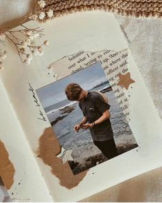 an open book with a photo of a boy on the page and words written in it