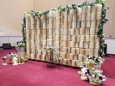 a bike is parked next to a wall made out of stacks of books and flowers