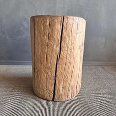 a wooden stump is sitting on the floor