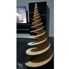 a wooden christmas tree sitting on top of a table