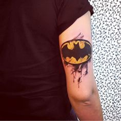 a batman tattoo on the left arm