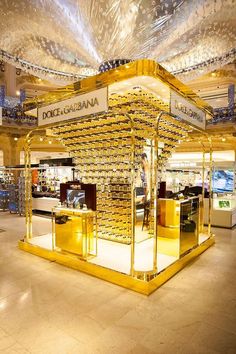 a display case in the middle of a store filled with gold bars and other items