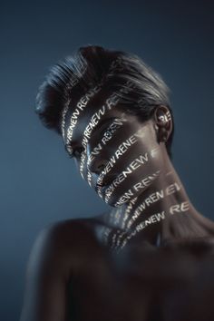 a woman's face with words written all over her body and neck on it