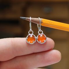 I designed these sterling silver prong settings to be small, wearable and modern. The 8mm carnelian gemstones add a great pop of color and look amazing being held in by the claws of the setting. The dangle measures 7/16 of an inch tall and with the lever backs have a 1 inch drop. Carnelian Earrings, Orange Carnelian, Being Held, The Claw, Sterling Earrings, Prong Setting, Sterling Silver Earrings, 1 Inch, Color Pop