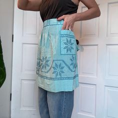 a woman wearing a blue and white apron