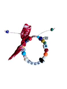 a colorful bracelet with beads and charms on the end that says rock'n'roll