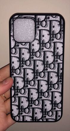 a hand holding up a cell phone case with cats on it's back cover