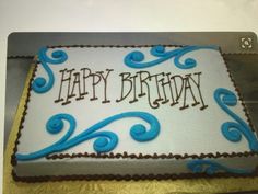 a birthday cake with blue swirls and the words happy birthday written on it in frosting