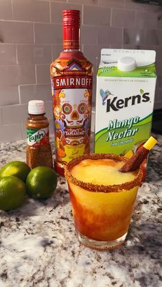 the ingredients to make an alcoholic cocktail sit on a counter top next to limes