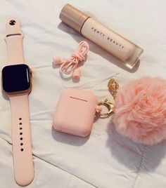 an apple watch, keychain, and other items are laying on a bed