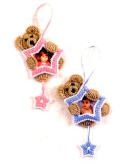 two teddy bears hanging from strings with pictures on them and one is holding a star ornament