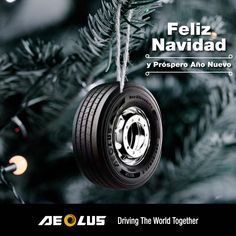 a christmas tree with a tire ornament hanging from it's side and the words feliz navidad written on top