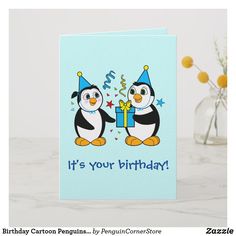 a birthday card with two penguins holding a present