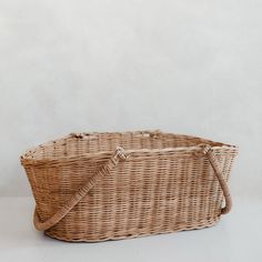 a wicker basket sitting on top of a white table