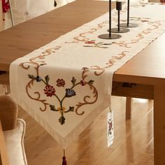 the table cloth is decorated with flowers and candles